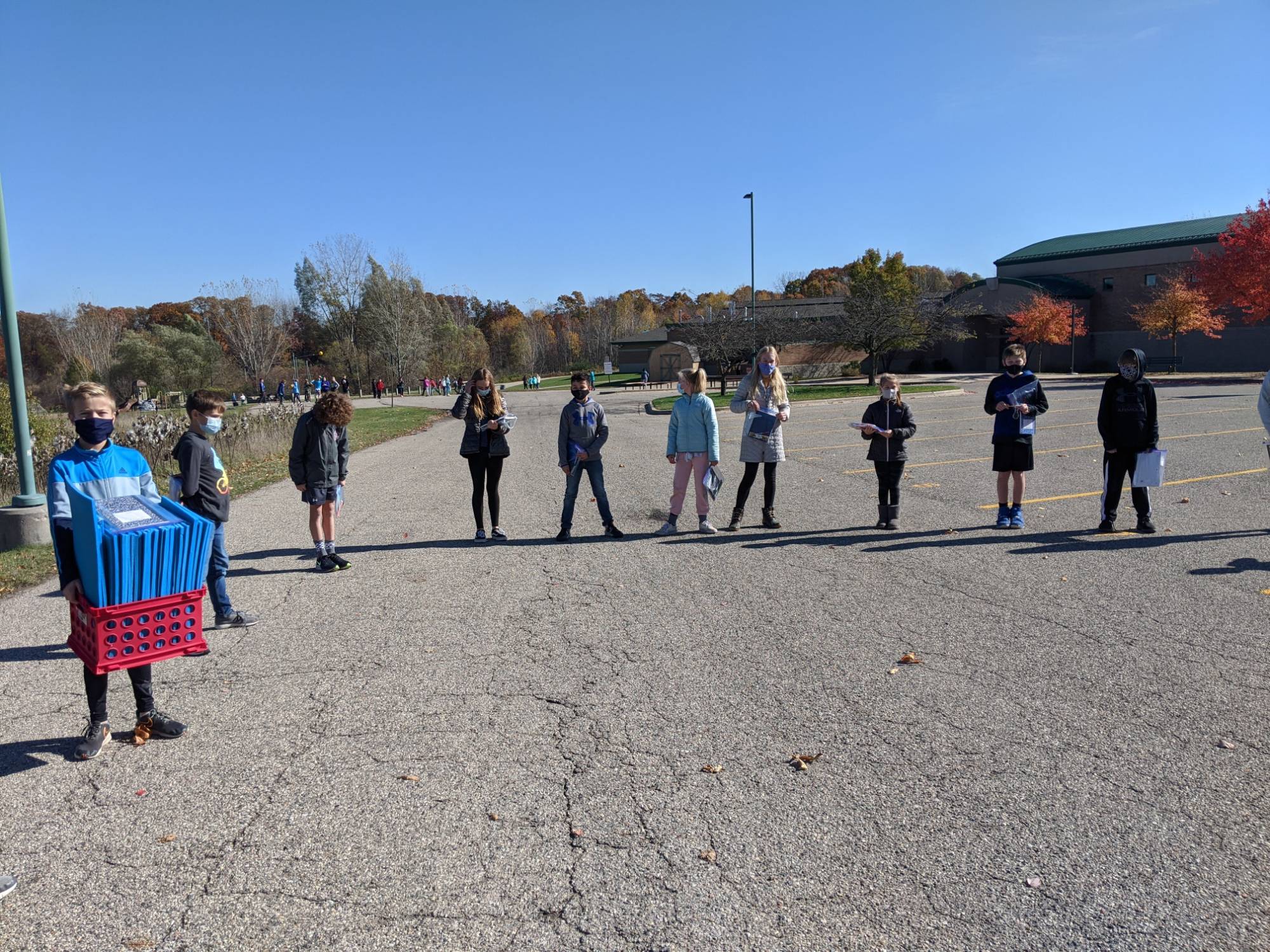 Students standing in semi-circle in parking lot